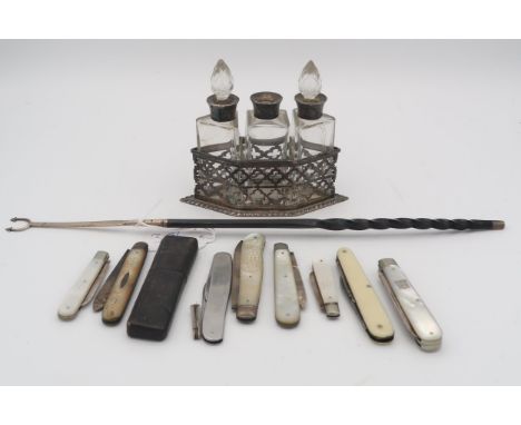 An Edwardian silver and glass three bottle condiment set, comprising three silver collared bottles (one lid missing), the bod