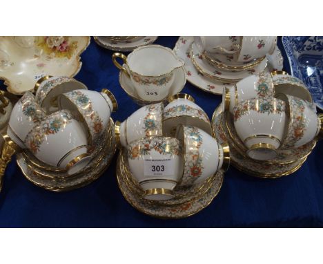 A Royal Stafford teaset, the white ground with turquoise and orange enamel detail on gilt border Condition Report:Available u