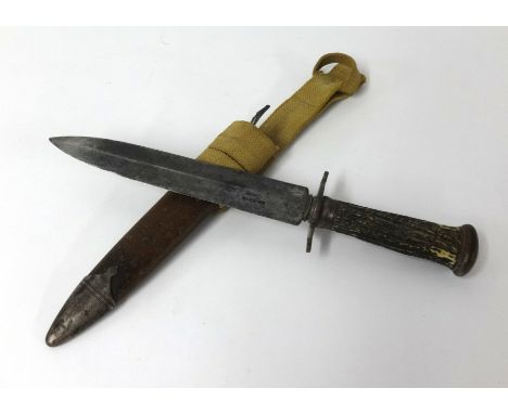 A hunting knife, the steel blade stamped Nagpome, with horn handle and scabbard (knife length 32cm).