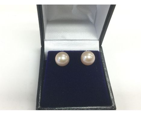 A pair of 9ct gold round pink cultured pearl ear studs. Shipping category A.