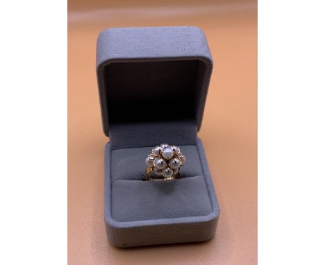 A 14ct gold and pearl set cluster ring. Size M.