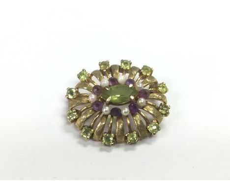 A 9ct gold brooch set with amethyst, peridot and pearl, approx 7.3g. Shipping category A.