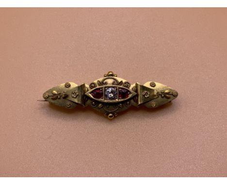 A Victorian 15ct gold diamond and ruby brooch. (A)