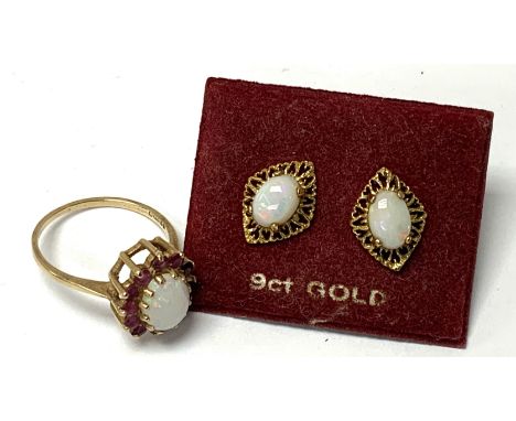 A 9ct gold and opal and garnet set ring with a pair of 9ct gold and opal stud earrings. (A)