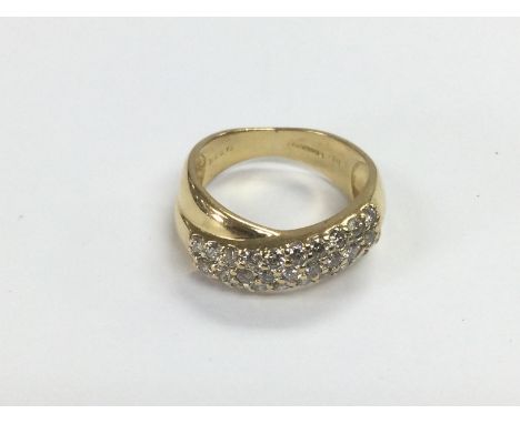 An 18ct gold diamond set crossover ring, approx 5.8g and approx size K-L. Shipping category A.