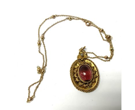 An yellow metal Edwardian cabochone Garnet and seed pearl pendant and chain. (A)