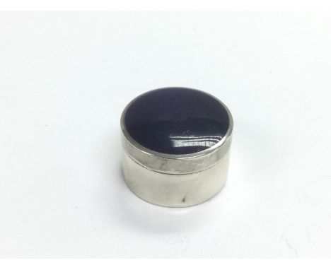 A silver and enamel pill box, approx width 3cm. Shipping category A.