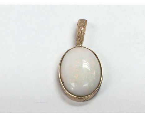 A yellow metal pendant set with an oval shaped white opal, measuring approx 19mm x 14mm, approx 4.5g. Shipping category A.