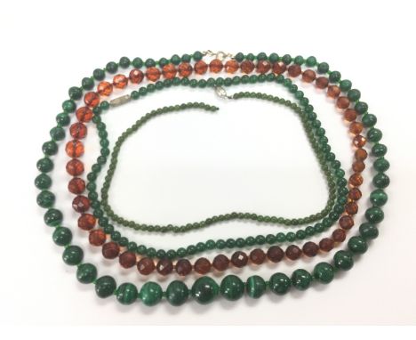 Four necklaces comprising malachite and jade examples. Shipping category A.