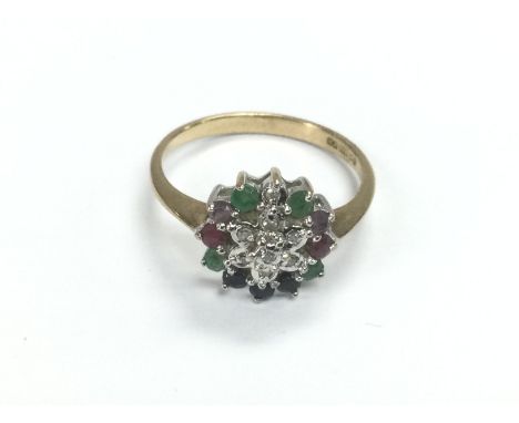 A 9ct gold cluster ring set with diamonds, ruby, sapphire and emerald. Approx 2g and approx size L-N. Shipping category A.