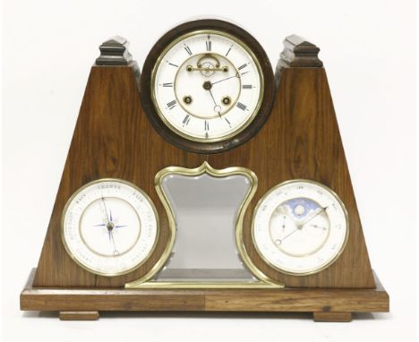 A twin train striking mantel clock,with white enamel dial and visible anchor escapement above a glass lenticle, flanked by ba