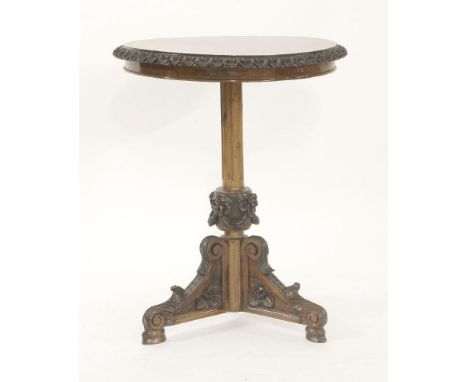 A Victorian burr walnut and mahogany lamp table,with a carved edge, turned and carved support, on a tripod back,58.5cm diamet