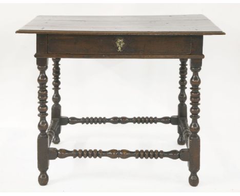 A Charles II oak side table,with plank top, over a drawer, on bobbin turned legs and all-round stretcher,90cm wide62cm deep72