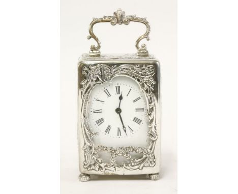A silver cased presentation carriage clock, by William Comyns, London 1899, the embossed case with the same scene in a panel 