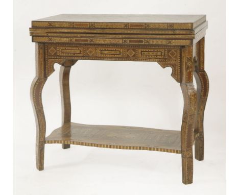 A Damascus games table,c.1920, with parquetry inlaid geometric patterns in bone, ivory, mother-of-pearl and exotic woods, the