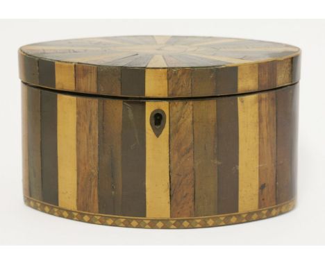 A George III oval twin compartment tea caddy,the cover with a central shell panel within radiating specimen woods,19cm wide11