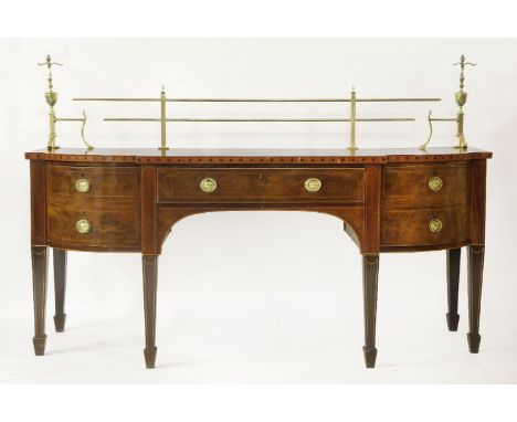 A George III mahogany and satinwood crossbanded sideboard,the back fitted with brass rails flanked with flaming urn finial mo