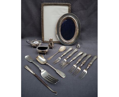 An Elizabeth II silver three piece cruet set, Birmingham, 1964, together with silver photograph frames, silver handled forks,