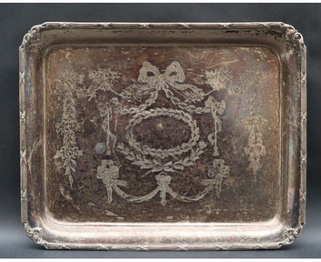 A George V silver dressing table tray of rectangular form with a line and bow border, the centre decorated with swags and wre