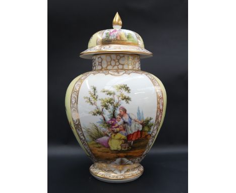 A 19th century porcelain vase and cover, the domed cover with a pointed gilt finial, with sectional decoration of flowers and