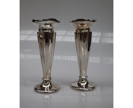 A pair of George V silver bud vases with a flared rim above a tapering body on a spreading foot, Chester, 1926, James Deakin 