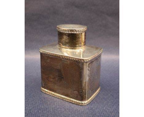 A George V silver tea caddy, the oval removable lid above a rectangular body, Chester, 1931, 9.5cm high, approximately 165 gr