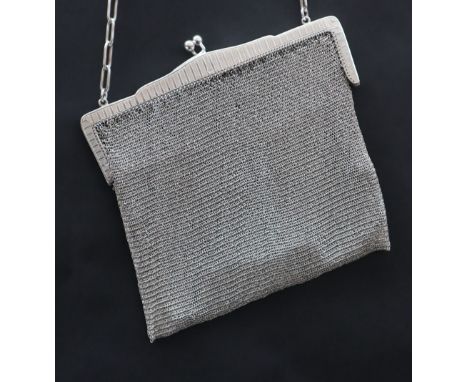 A George V silver mesh purse, with a crossover clasp and chain handle, import marks for London, 1913, overall approximately 3