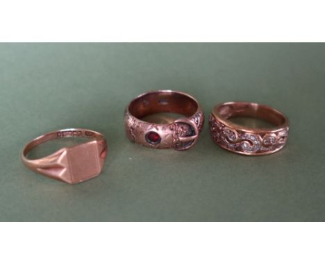 A 9ct yellow gold signet ring, size R 1/2 together with a gem set 9ct gold buckle ring, size N and a 9ct gold diamond set rin