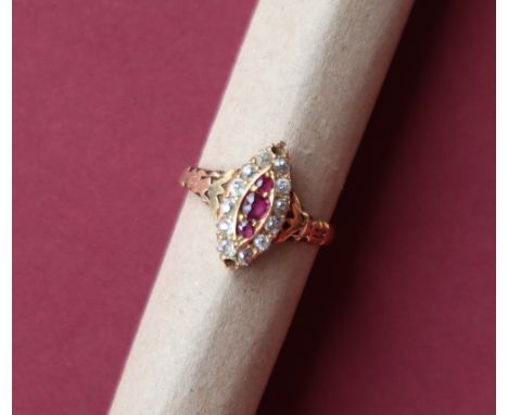 A ruby and diamond ring, of pointed oval shape set with three round faceted rubies and twelve diamonds to an 18ct yellow gold