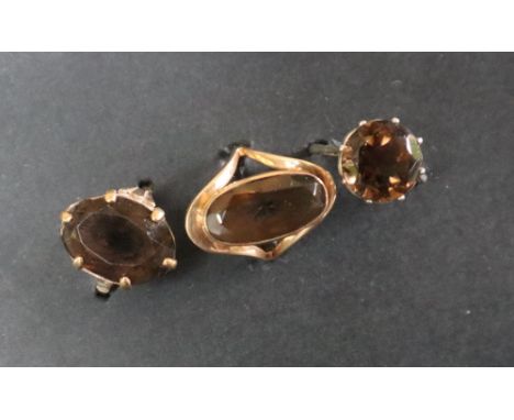 A 9ct gold dress ring set with an oval faceted smoky quartz, size m, together with another 9ct gold smoky quartz ring, size  