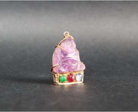 A Chinese amethyst Buddhistic pendant mounted in yellow metal, marked 14k, set with cabochon emerald, ruby and sapphire, 3cm 