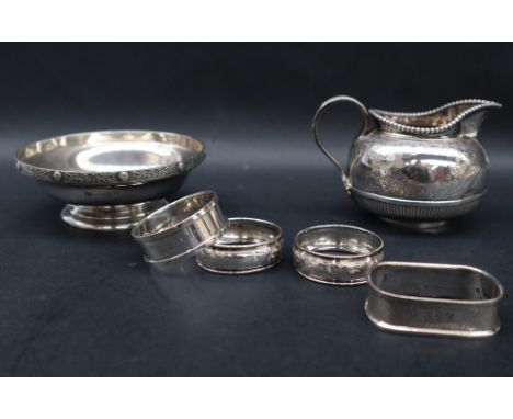 A Victorian silver cream jug with a beaded edge, the half reeded body decorated with leaves, London, 1886, together with a si