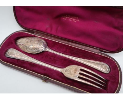 A Victorian silver christening set of a spoon and fork, with scrolling decoration, Sheffield, 1871, cased, approximately 85 g