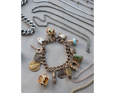 A 9ct yellow gold bracelet set with numerous charms including a lighter, telephone, miners lamp, St. Christopher, Key etc ove