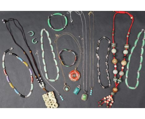 A carved jade pendant on a string necklace together with other jade necklaces, bracelets, pendants etc 