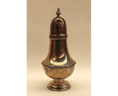 A George V silver sugar caster, with a turned finial and domed top with pierced decoration, above a baluster body on a spread