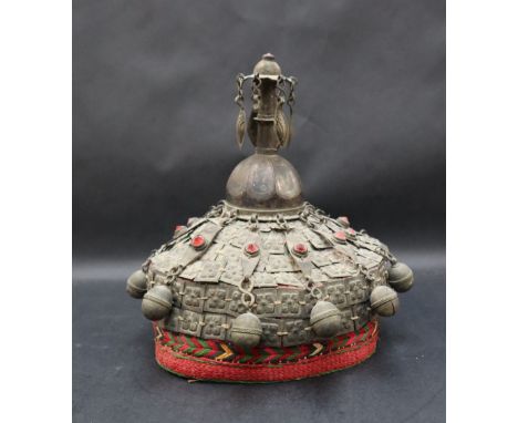 A Headdress / skull cap possibly Turkmenistan with a central finial, the body comprising white metal platelets and red stones