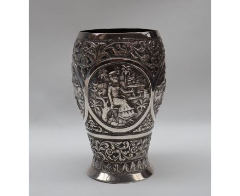 An Indian white metal beaker, decorated with figures, elephant, lion, flowers, leaves etc, marked M R BHUJ, 12.5cm high, appr