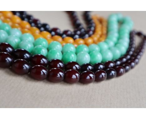 A Cherry amber / bakelite bead necklaces, with oval beads ranging in size from, 23mm to 8mm, approximately 52 grams together 