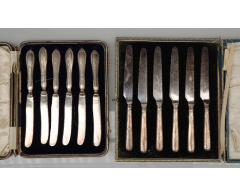 A set of six George V silver handled knives, Sheffield, 1922 together with another set of silver handled knives, both cased