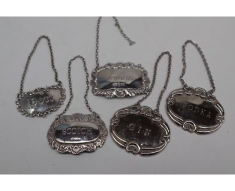 An Elizabeth II silver wine label of oval form, decorated with shells and leaves, inscribed Scotch, Sheffield, 1978 together 