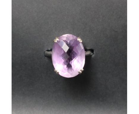 An amethyst dress ring, set with an oval cut amethyst, approximately 19mm x 14mm, to an 18ct white gold setting and shank, si