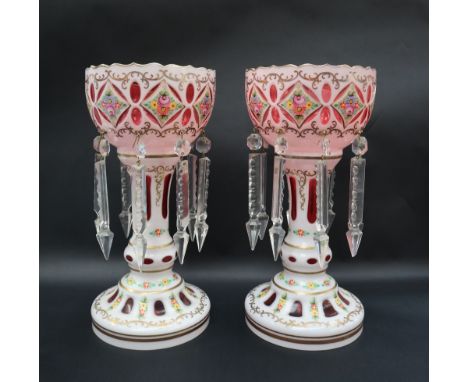 A pair of Victorian ruby and white flash glass table lustres painted with flowers and leaves, 29.5cm high  CONDITION REPORT: 