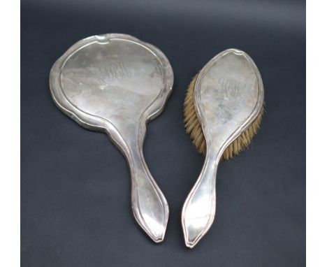 A George V silver backed hand mirror and matching brush, Birmingham, 1920, William Aitken