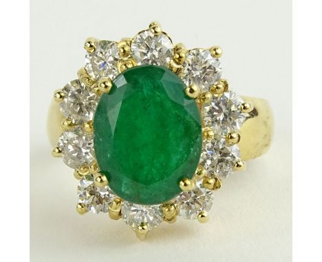 Lady's 4.00 Oval Cut Emerald, 1.80 Carat Round Cut Diamond and 14 Karat Yellow Gold Ring. Emerald with vivid saturation of co