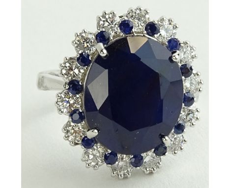 Lady's 11.50 Carat Oval Cut Sapphire, 1.40 Carat Round Cut Diamond and 14 Karat White Gold Ring. Sapphire with vivid blue col