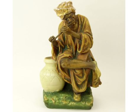 Early 20th Century Austrian Amphora Porcelain Figure, Arab Man Playing Flute. Impressed marks to base. Rubbing to Gilt Decora