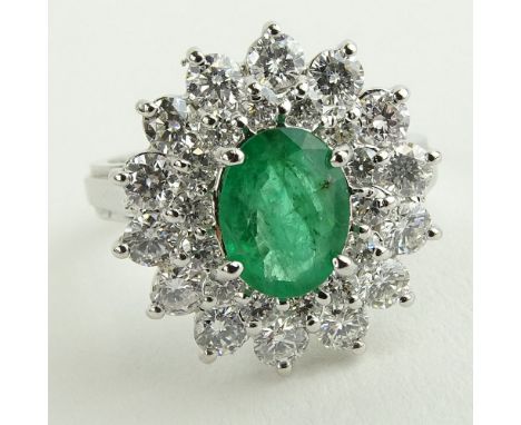 Lady's 1.60 Carat Oval Cut Emerald, 1.45 Carat Round Cut Diamond and 14 Karat White Gold Ring. Emerald with vivid saturation 