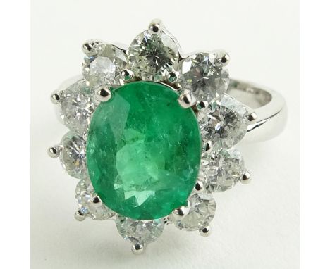 Lady's 2.40 Carat Oval Cut Emerald, 2.15 Carat Round Cut Diamond and 14 Karat White Gold Ring. Emerald with vivid saturation 