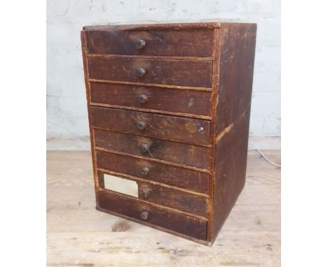 A cabinet of assorted mainly vintage watch spares.